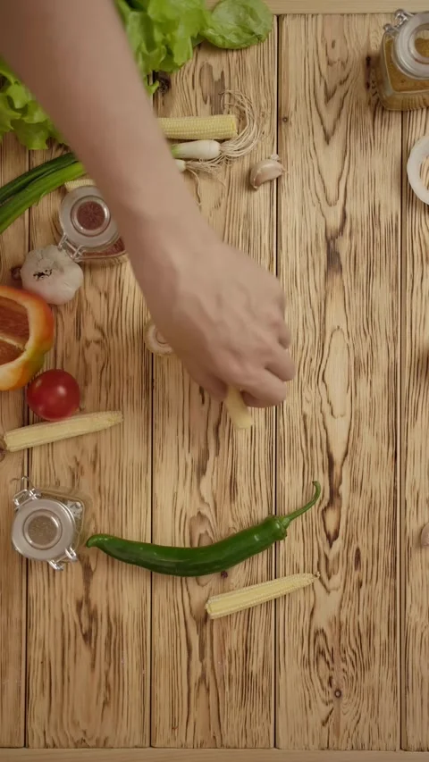 Vertical of People taking vegetables and another ingredients from table Stock Footage 276775282