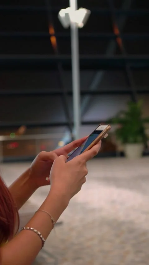 Vertical, a person browsing a smartphone at modern airport Stock Footage 292910580