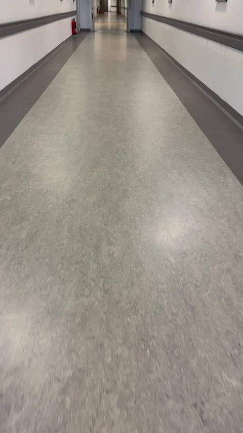Vertical. Personal perspective walking in the long empty corridor. Stock Footage 340756634