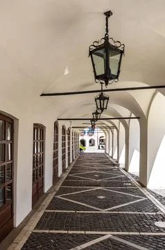 Vertical Perspective of Ancient Vaulted Arches and Street Lamps Stock Photos