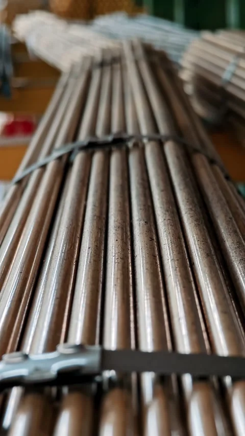 Vertical perspective of long copper pipes strapped together. Industrial storage Stock Footage 329293915