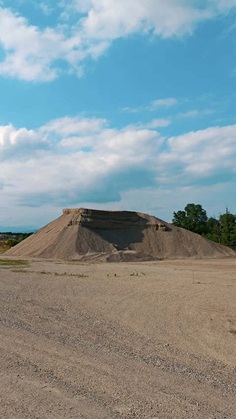 Vertical perspective of massive sand and gravel pile at building site Stock Footage 343789337