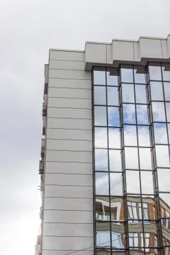 Vertical perspective shot of multiple floor of a glazing facade building with Stock Photos