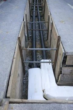Vertical perspective of a trench with pipework during construction work Stock Photos