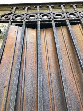 Vertical perspective view of old wrought iron gate  Stock Photos