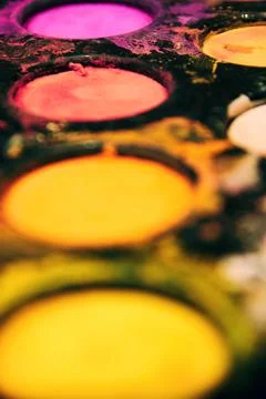 Vertical perspective view of paints palette with orange and pink colors Stock Photos