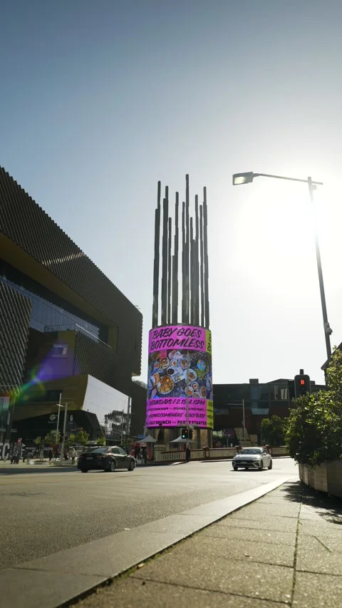 Vertical Perth traffic passes Yagan Square digital tower 6K 스톡 동영상 311492474