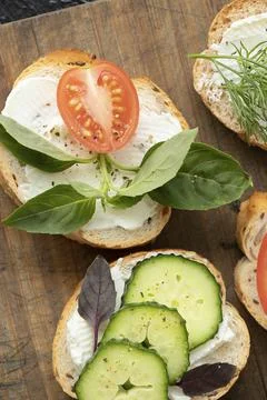 Vertical photo with closeup various vegetable sandwiches with cream cheese, t Stock Photos
