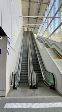 Vertical photo of an empty escalator at a train station Stock Photos