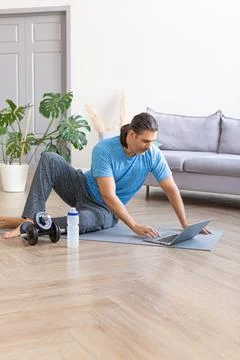 Vertical photo of a man looking for exercise routines online. Home online Stock Photos