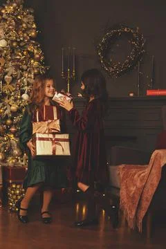 Vertical photo, retro processing, two girls in retro dresses, standing next to a Stock Photos