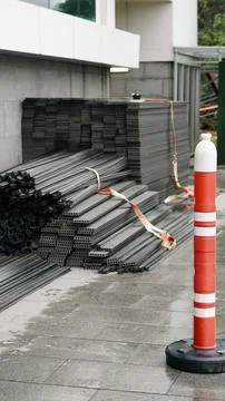 Vertical photo of stacked composite decking boards and construction materials Stock Photos