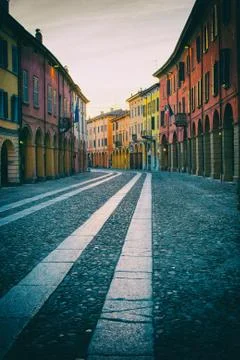 Vertical photo of a street with colorful edifices. Stock Photos
