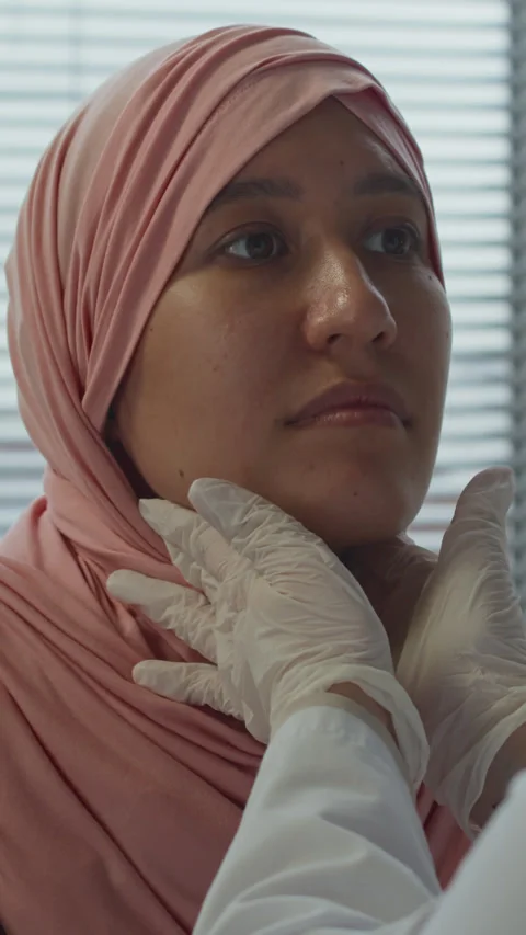 Vertical of Physician Checking Lymph Nodes of Muslim Female Patient Stock Footage 299197156
