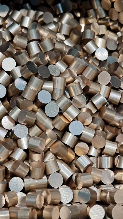 Vertical pile of small cylindrical brass blanks. Mass production of metal Stock-Footage 329327251
