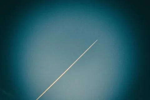 Vertical plane trace in blue sky. Stock Photos