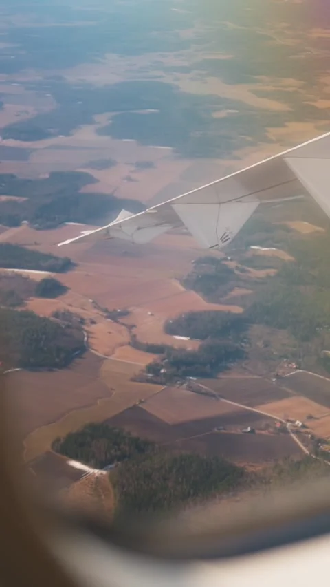 Vertical plane window view over patchwork farmland and forest blocks, with Stock Footage 334013361