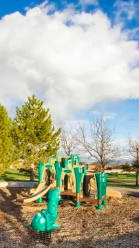 Vertical Playground in the middle of a circular pathway and vast field with Stock Photos