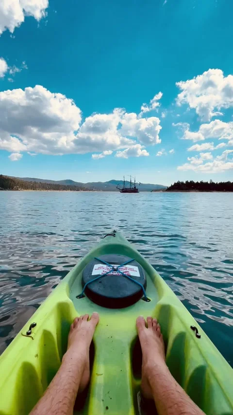 Vertical point of view kayaking across a calm scenic lake Stock Footage 341068344