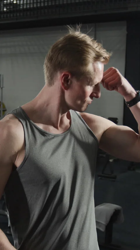 Vertical Portrait of Athletic Man Flexing Biceps, Smiling in Fitness Gym Stock Footage 339887865