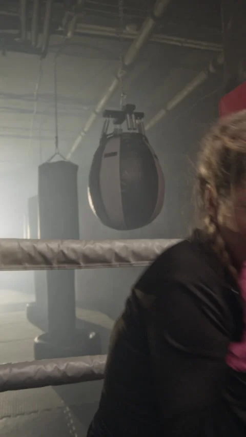 Vertical Portrait of Athletic Woman Shadowboxing and Punching Towards Camera Stock Footage 340388341