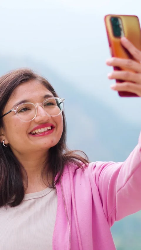 Vertical portrait of beautiful Indian young woman taking selfie with mobile phon Stock Footage 280967065