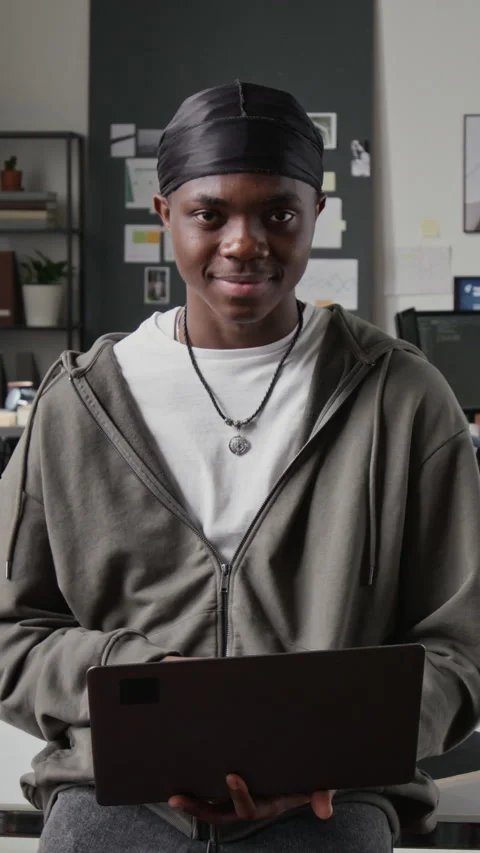 Vertical of Portrait of Black Programmer Holding Laptop and Smiling in Office Stock-Footage 336708118