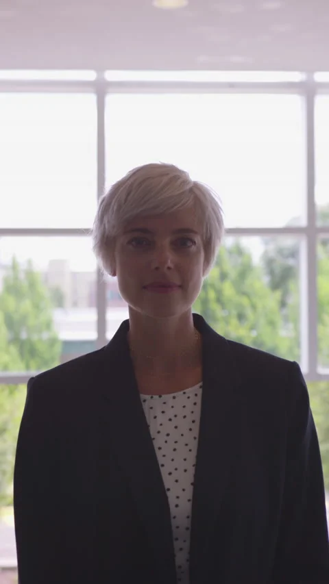 Vertical Portrait of Blonde 20 Something Business Woman with Pixie Haircut Video stock 208778525