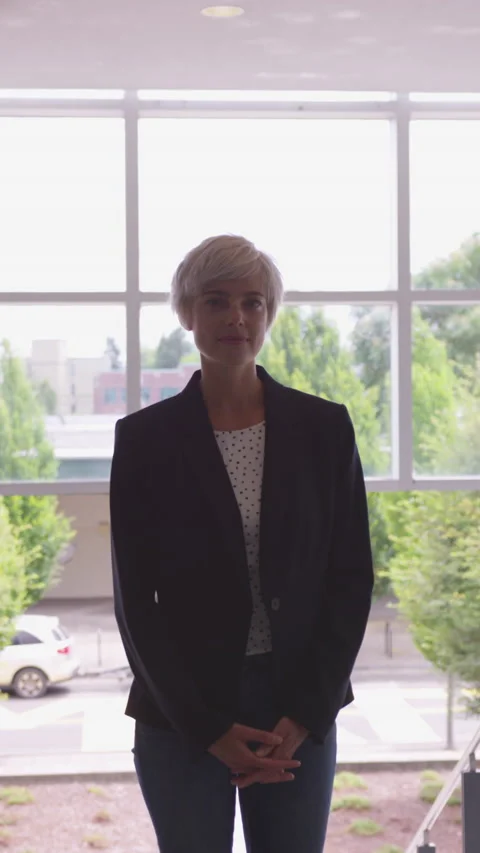 Vertical Portrait of Blonde 30 Something with Pixie Haircut Downtown, daylight Stock Footage 208778224