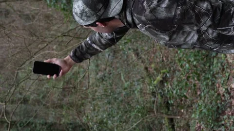 Vertical portrait Camouflaged Explorer Seeking Cell Signal in Dense Forest:.. Stock Footage 265768472