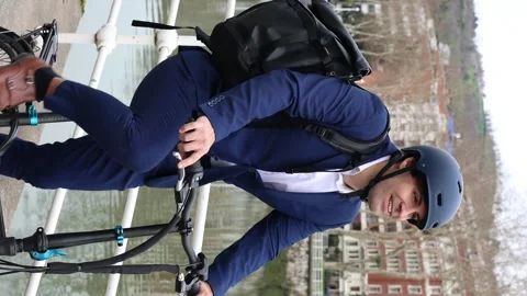Vertical portrait Close-p of Smiling Businessman with Helmet and Backpack C.. Stock Footage 267448937