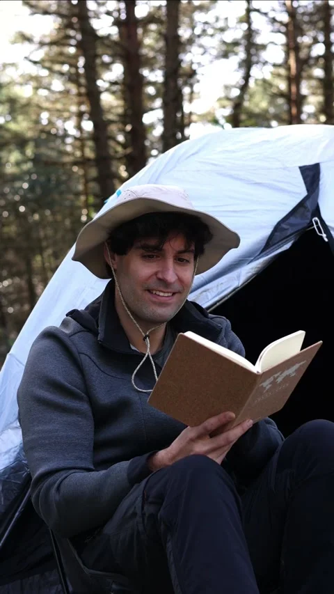 Vertical portrait Forest Tranquility: Camper's Reading Retreat at summer Stock-Footage 270414972