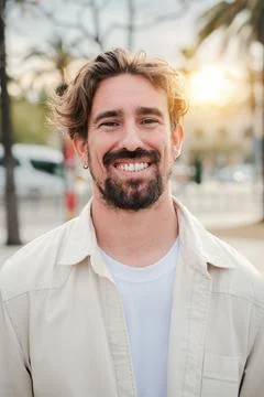 Vertical portrait of handsome bearded guy with perfect white teeth smiling and Stock Photos