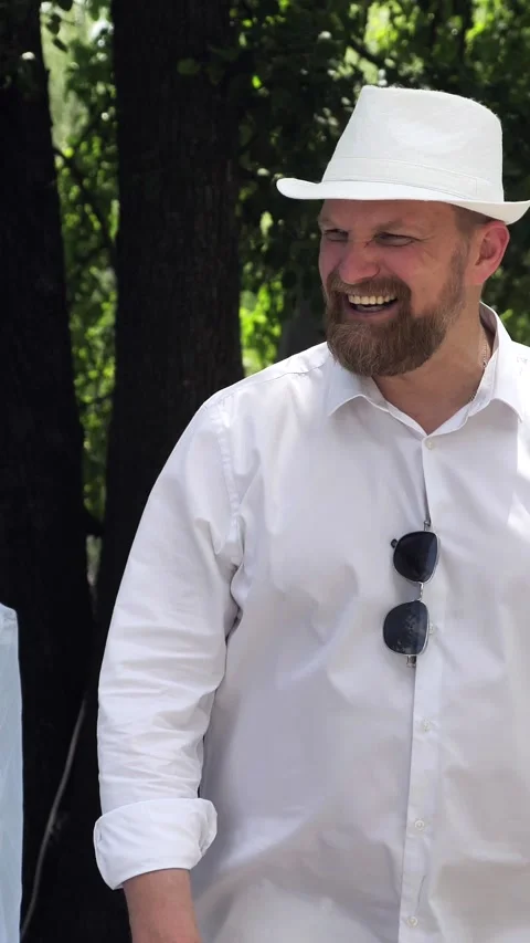 Vertical portrait of happy handsome young man smiling and standing outdoors in Stock Footage 310724250