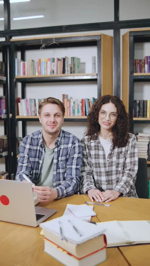 Vertical Portrait of happy Students collaborate on a project in a library with Stock Footage 308668247