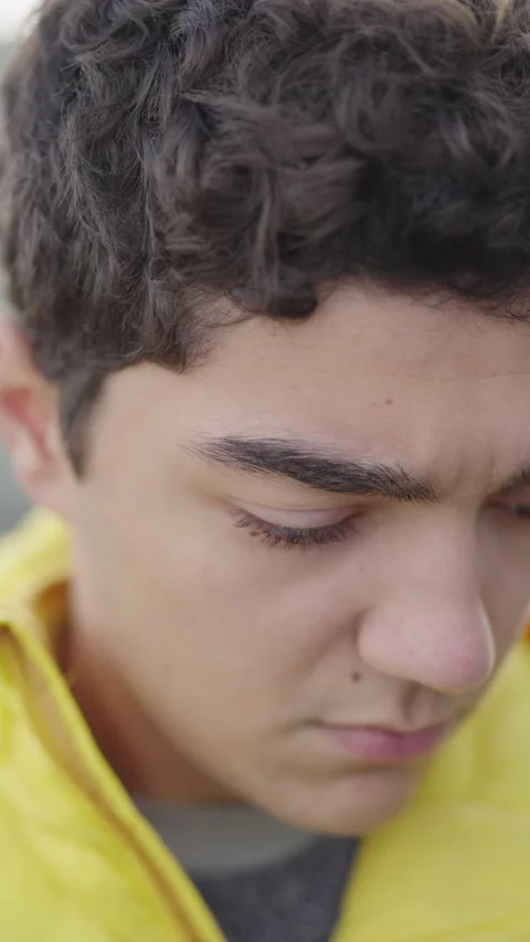 Vertical portrait of hispanic sad boy, then looking at camera. Stock Footage 222568045