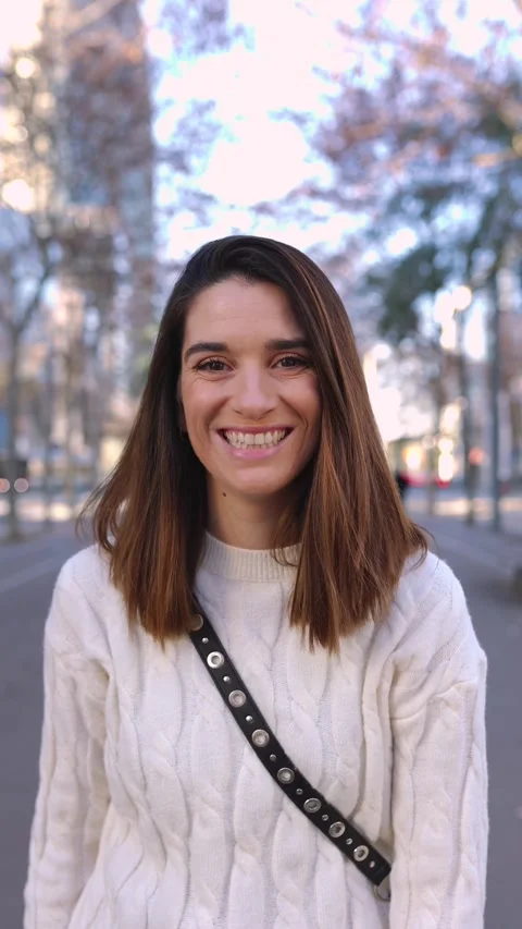 Vertical portrait of joyful young pretty woman standing at city street. Stock Footage 256352828