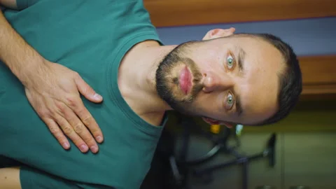 Vertical portrait of man putting hand on heart. young caucasian male shows Stock Footage 168697978