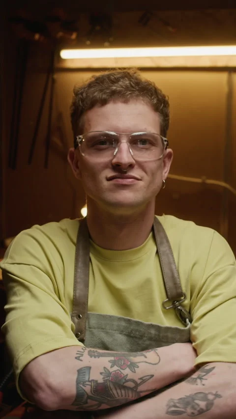 Vertical Portrait of Man Putting on Safety Glasses in Carpentry Workshop Stock Footage 340391650