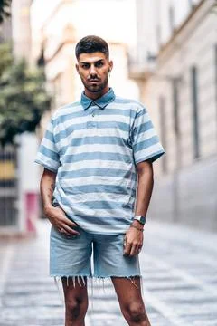 Vertical portrait of a man standing facing the camera in the street Stock Photos