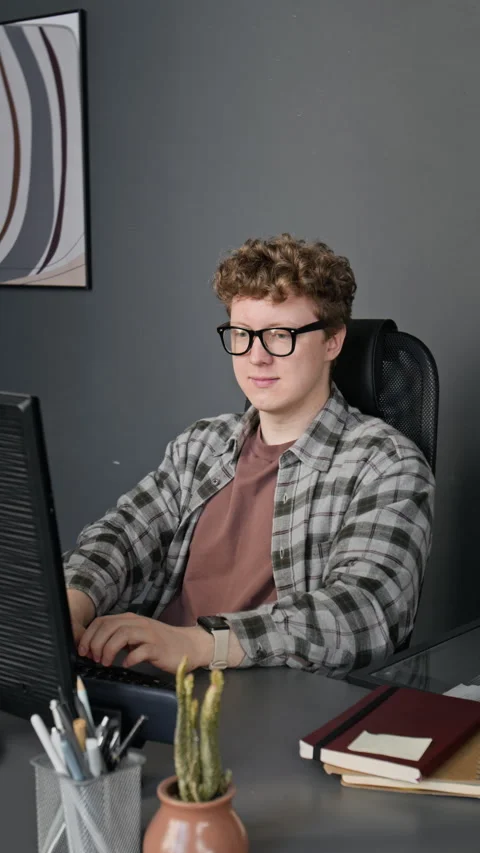 Vertical Portrait of Man Typing on Computer, Removing Glasses, Smiling Stock Footage 336719283