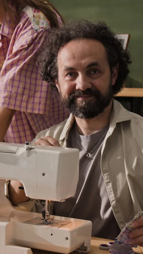 Vertical Portrait of Middle Aged Tailor Smiling at Sewing Machine Stock Footage 341940949