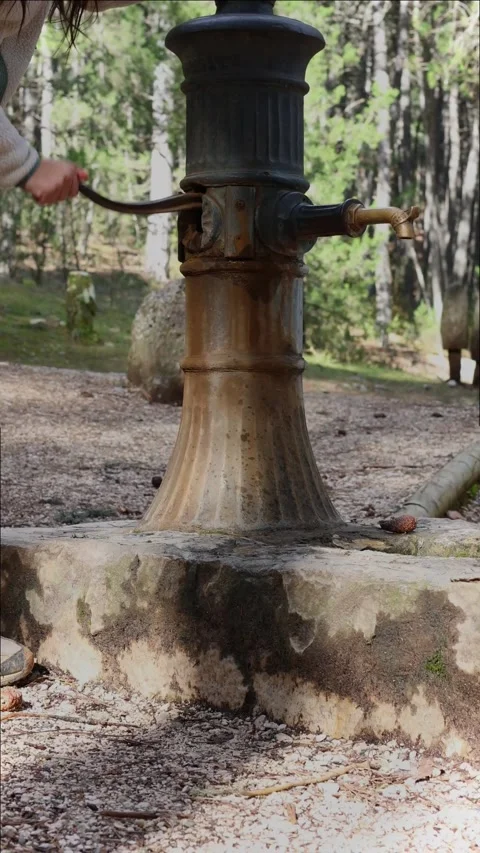 Vertical portrait Obtaining Potable Water: Woman Operating a Water Pump Vidéo 268643033