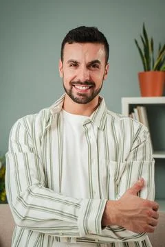 Vertical portrait of one handsome guy with perfect white teeth smiling at home Stock Photos