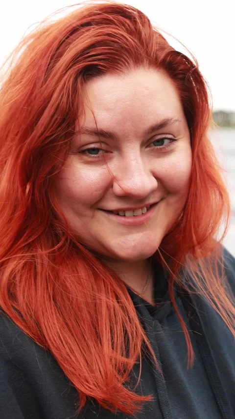 Vertical portrait shot of a smiling red-haired woman outdoors. Lifestyle, r.. Stock Footage 346221405