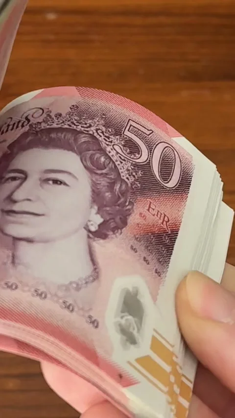 Vertical portrait slow motion flick through stack of £50 British notes Stock Footage 306220762