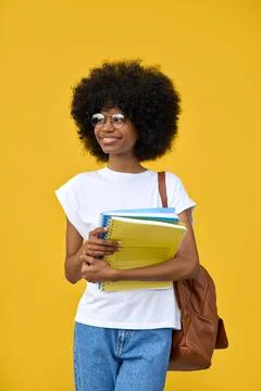 Vertical portrait of a smart student looking aside on yellow background. Stock Photos