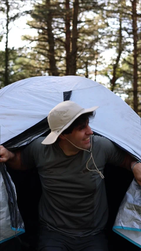 Vertical portrait Smiling Camper Emerges from Tent in Summer Sunrise Stock Footage 270415032
