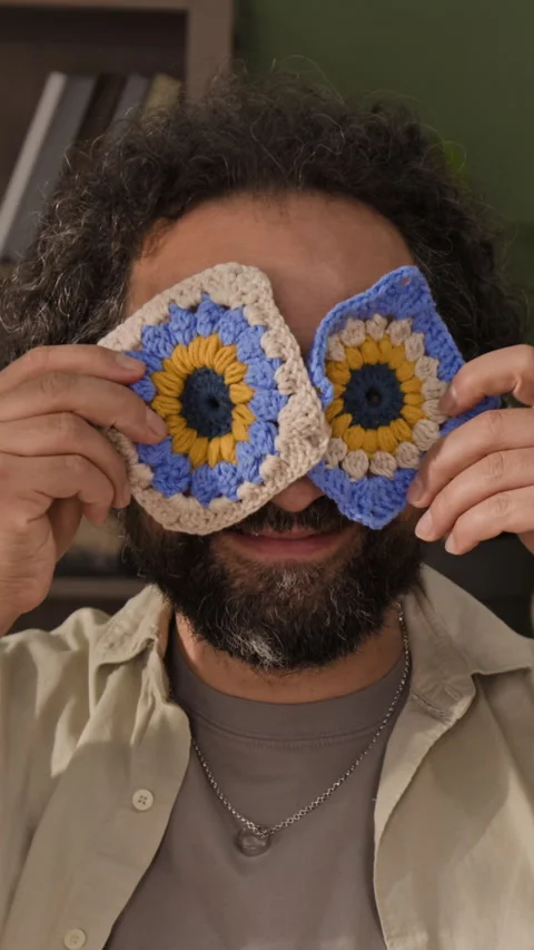Vertical Portrait of Smiling Middle Aged Man Covering Eyes with Crochet Squares Stock Footage 341940969