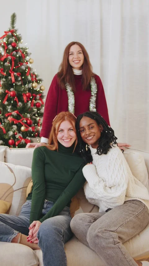 Vertical portrait of three multiracial friends joyfully celebrate New Year and Stock Footage 319451388